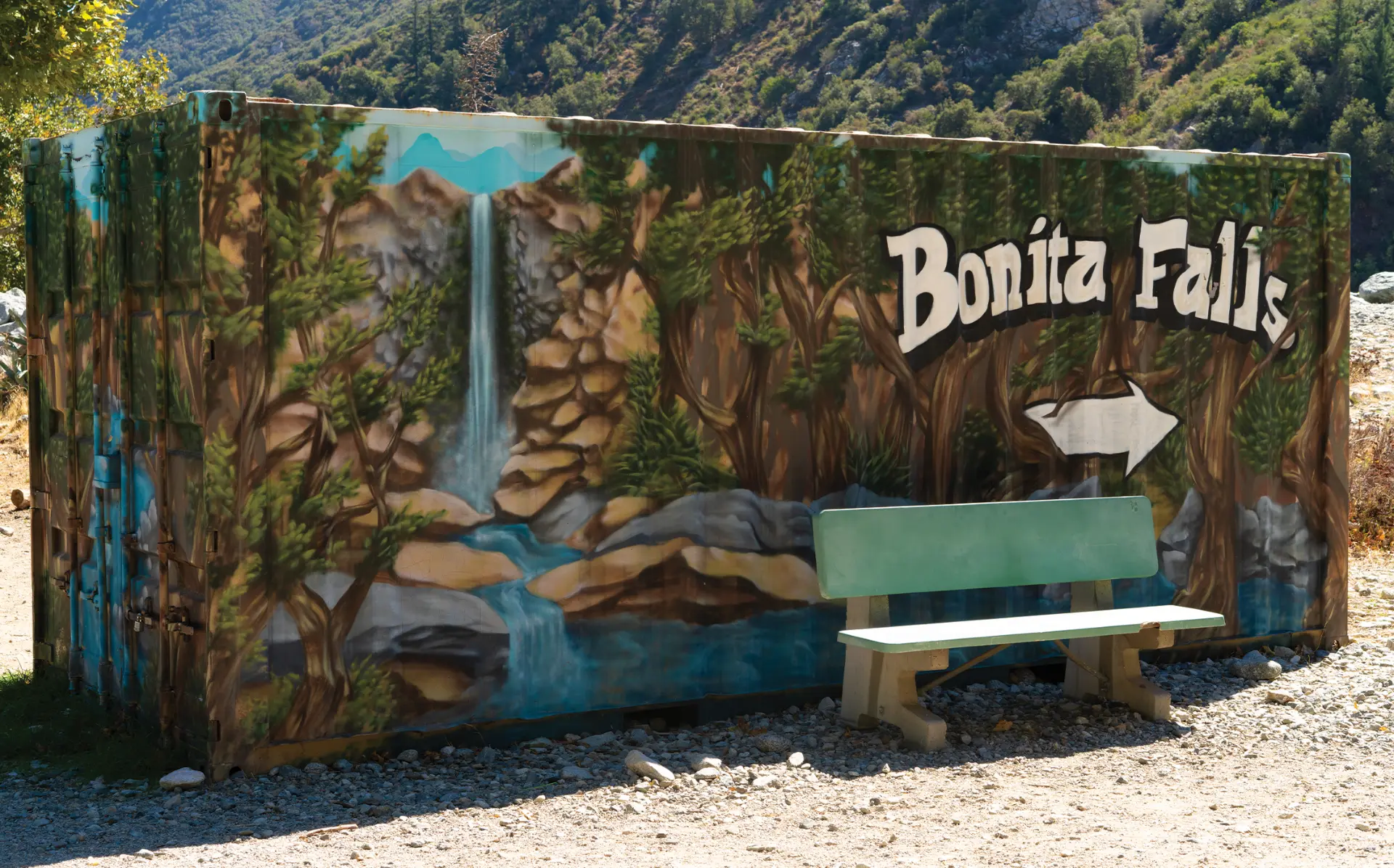 The painted Bonita Falls mural and bench at the trailhead