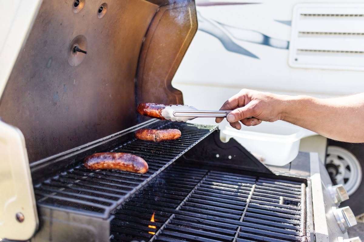 Sausages on the grill at an RV campsite